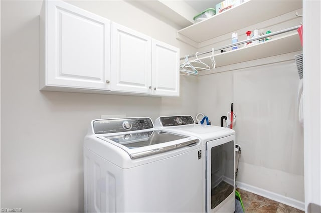 washroom with cabinet space and washing machine and clothes dryer