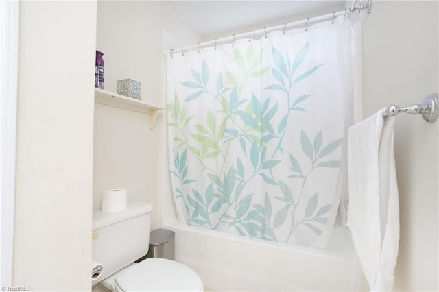 bathroom with shower / tub combo with curtain and toilet