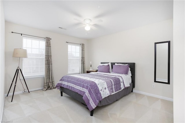 bedroom with carpet floors, a ceiling fan, visible vents, and baseboards