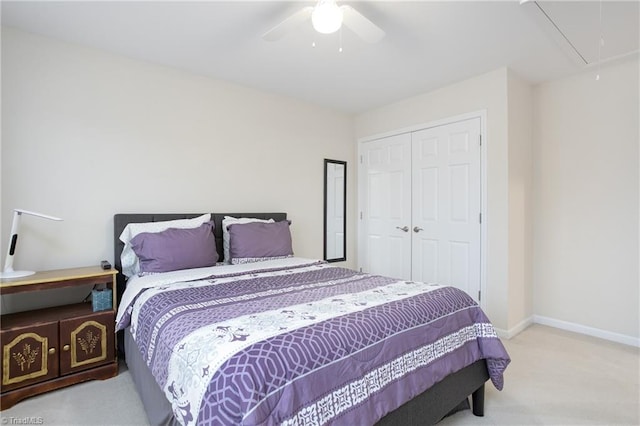 bedroom with attic access, baseboards, a ceiling fan, carpet floors, and a closet