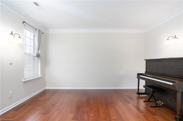 sitting room with ornamental molding, baseboards, and wood finished floors