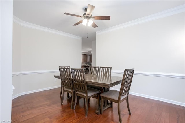 dining area with ornamental molding, wood finished floors, a ceiling fan, and baseboards