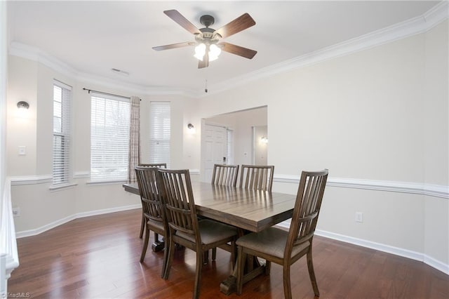 dining room featuring baseboards, ornamental molding, and dark wood-type flooring