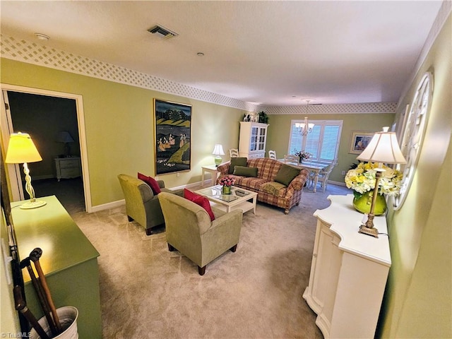 living room with light carpet and an inviting chandelier