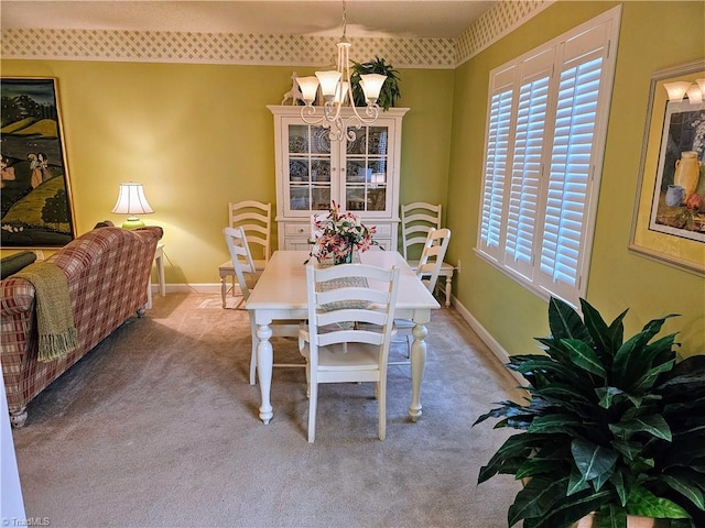 dining room with light carpet and an inviting chandelier