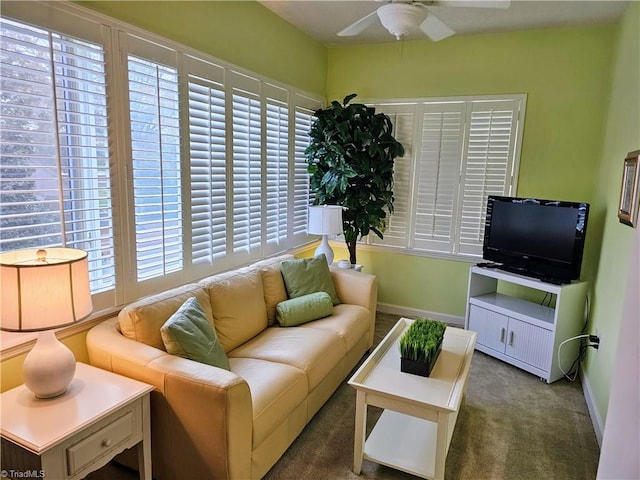 carpeted living room with ceiling fan