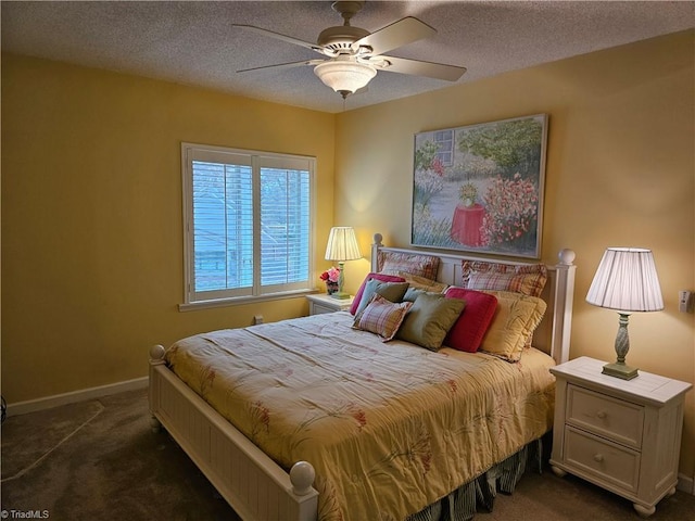 bedroom with ceiling fan, a textured ceiling, and dark carpet