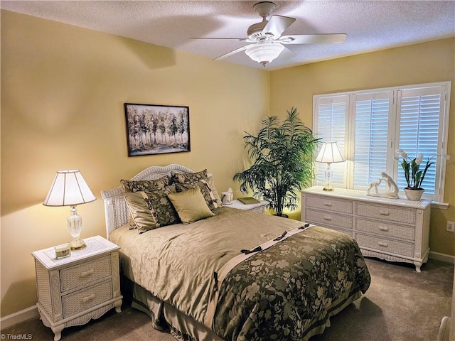 carpeted bedroom featuring ceiling fan and a textured ceiling