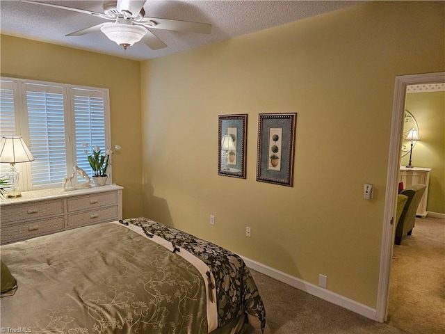 carpeted bedroom with a textured ceiling and ceiling fan