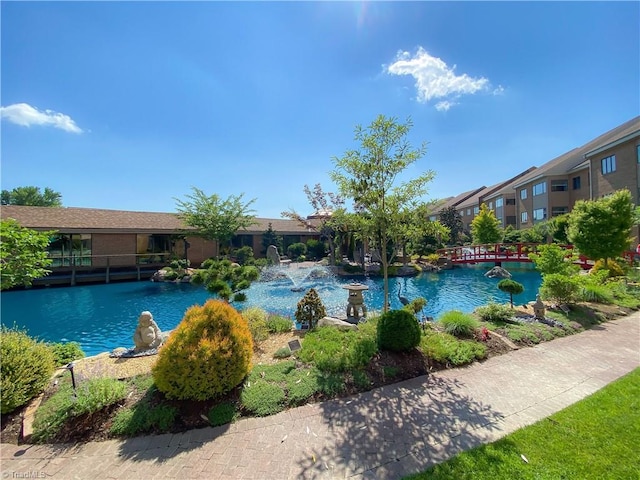 view of swimming pool featuring a water view