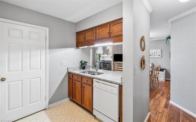 kitchen featuring ornamental molding, dishwasher, and sink