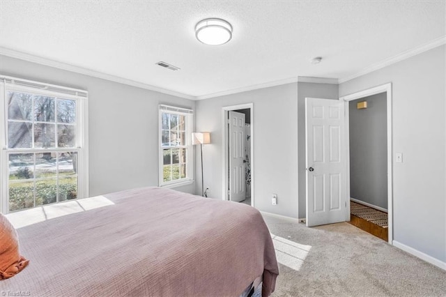 bedroom featuring ornamental molding, light carpet, and a textured ceiling