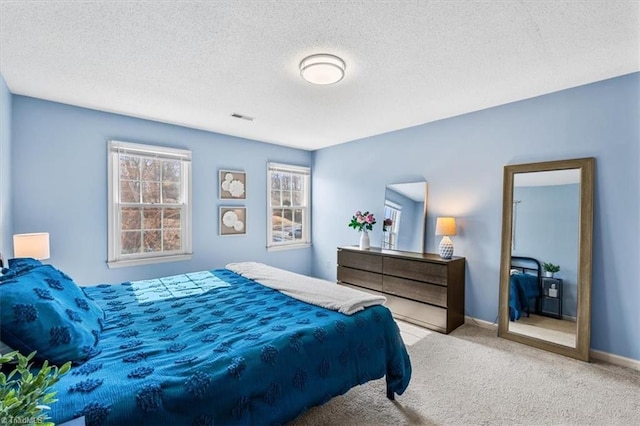 carpeted bedroom featuring a textured ceiling