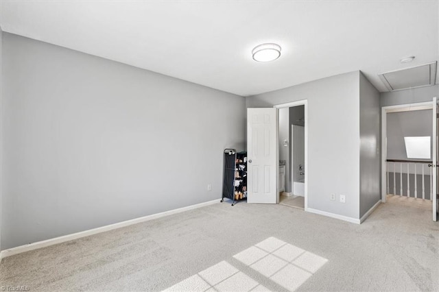 unfurnished bedroom featuring light carpet and ensuite bathroom