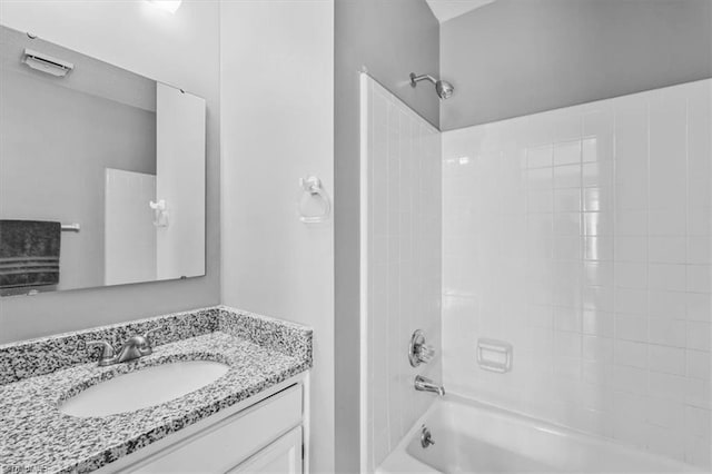 bathroom featuring washtub / shower combination and vanity