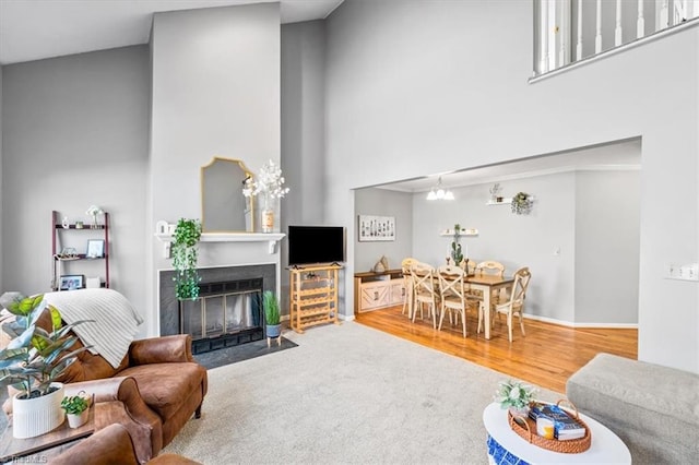 living room with carpet and a towering ceiling