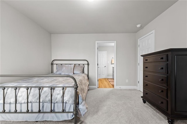 carpeted bedroom with baseboards and connected bathroom