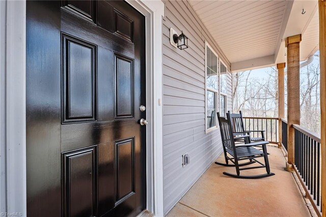view of exterior entry with covered porch
