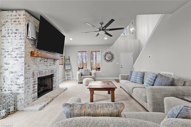 living room featuring a ceiling fan, carpet, a fireplace, baseboards, and recessed lighting