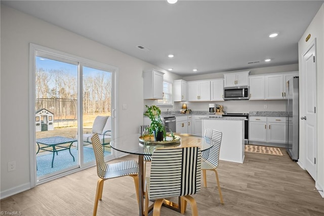 dining area with light hardwood / wood-style flooring