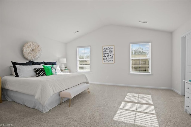 bedroom with light colored carpet and vaulted ceiling