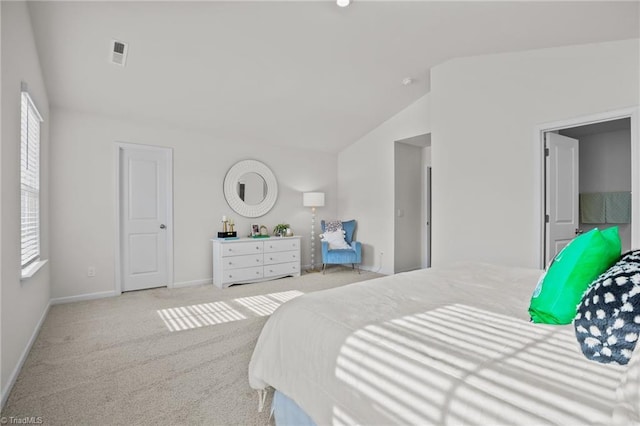 carpeted bedroom featuring vaulted ceiling