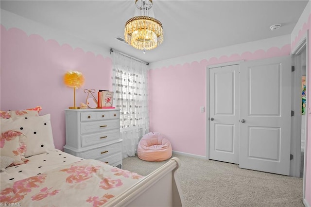 bedroom featuring an inviting chandelier and light carpet