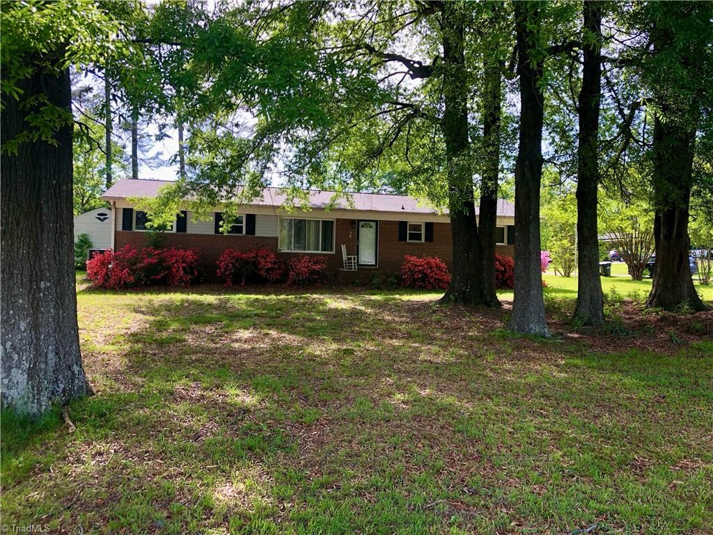 ranch-style house with a front lawn and brick siding