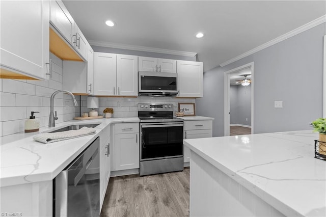 kitchen featuring sink, dishwasher, electric stove, and white cabinetry