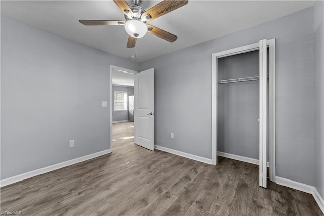 unfurnished bedroom with ceiling fan, hardwood / wood-style floors, and a closet