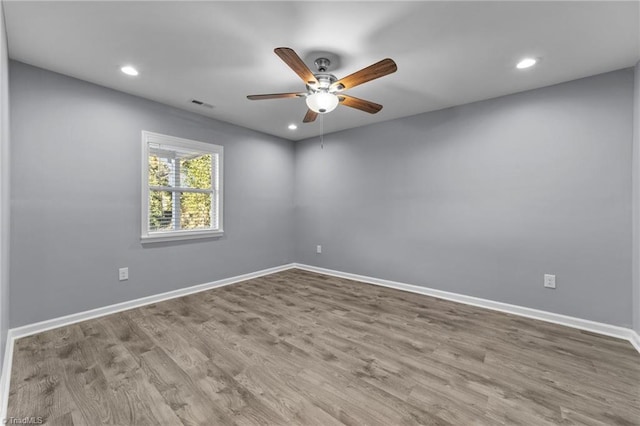 spare room with ceiling fan and light wood-type flooring