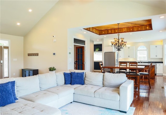 7768 Pinecone Ln, Hickory, NC 28602 - living room with hardwood / wood-style flooring, vaulted ceiling, healthy amount of natural light, a chandelier, and recessed lighting