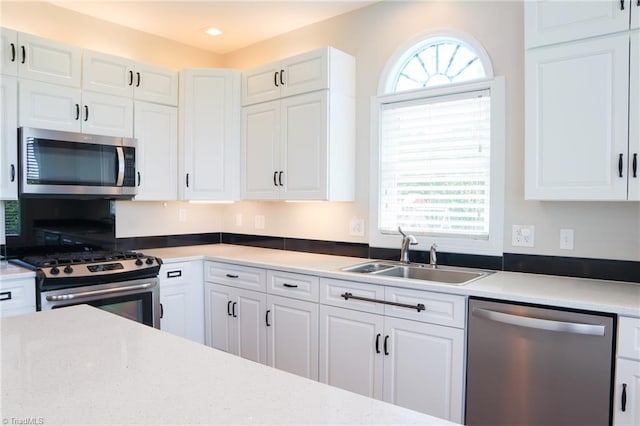 7768 Pinecone Ln, Hickory, NC 28602 - kitchen featuring appliances with stainless steel finishes, a sink, and white cabinets