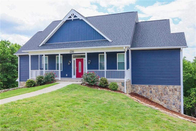 7768 Pinecone Ln, Hickory, NC 28602 - view of front of house with a front yard, covered porch, a shingled roof, and stone siding