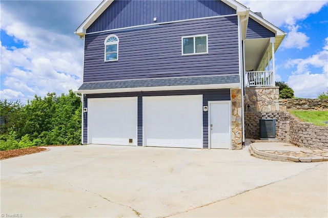 7768 Pinecone Ln, Hickory, NC 28602 - view of side of property with an attached garage, driveway, central AC unit, and a shingled roof