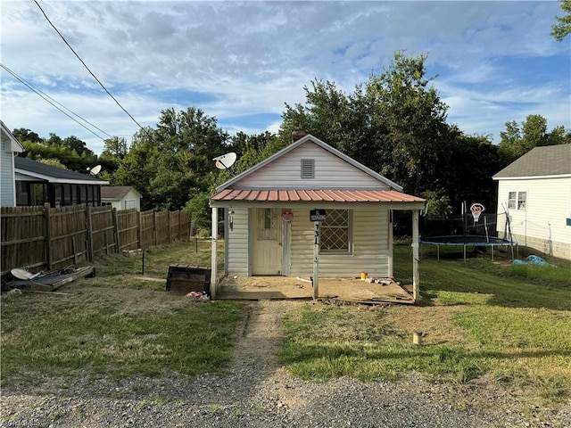 bungalow-style house with a trampoline and a front lawn