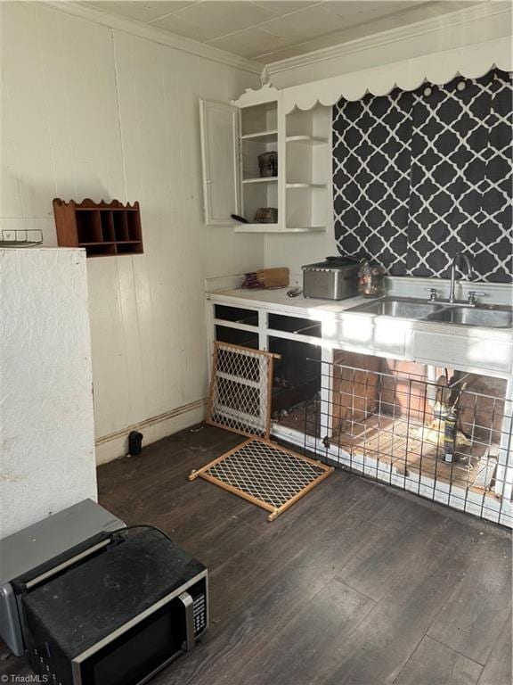 kitchen with crown molding and dark wood-type flooring