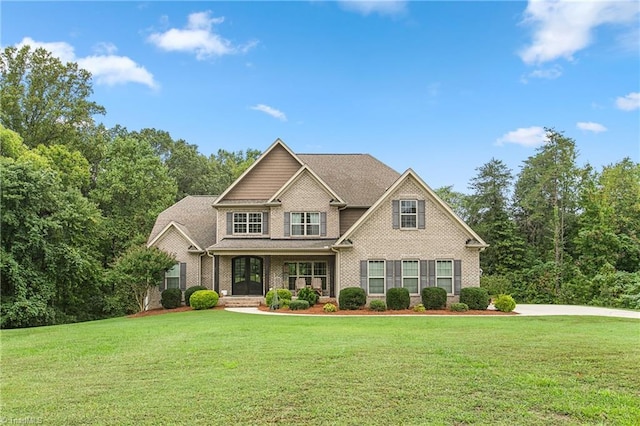 craftsman house featuring a front lawn and a porch