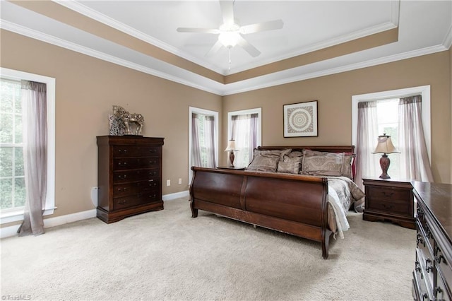 bedroom with light carpet, ceiling fan, crown molding, and a raised ceiling