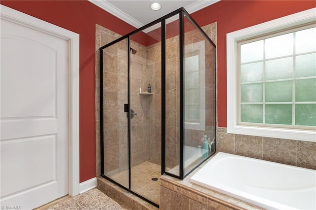 bathroom with plenty of natural light, ornamental molding, and plus walk in shower