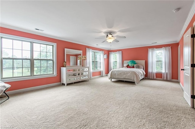 carpeted bedroom with ceiling fan and crown molding