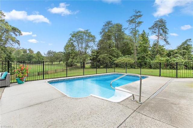 view of swimming pool with a lawn and a patio