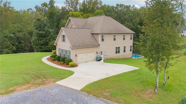 view of side of property with a lawn and a garage