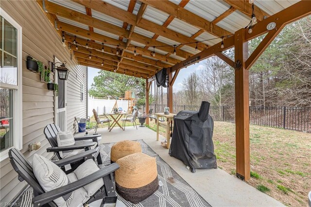 view of patio / terrace with a fenced backyard, a grill, and outdoor dining space
