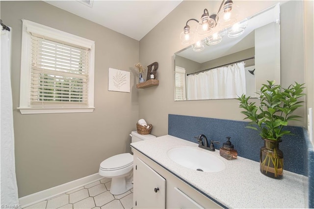 795 Morris Rd, Winston-Salem, NC 27101 - bathroom featuring vanity, toilet, and baseboards