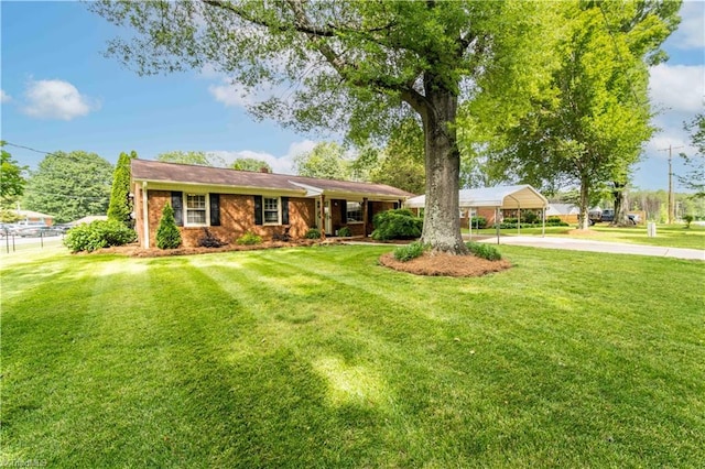 795 Morris Rd, Winston-Salem, NC 27101 - single story home with driveway, a carport, and brick siding