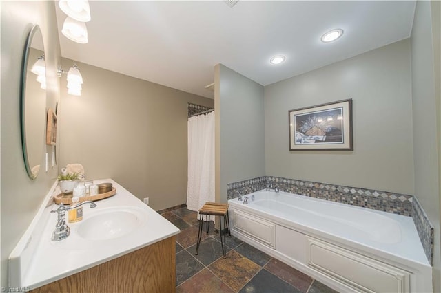 795 Morris Rd, Winston-Salem, NC 27101 - bathroom with stone tile flooring, a garden tub, double vanity, recessed lighting, and baseboards