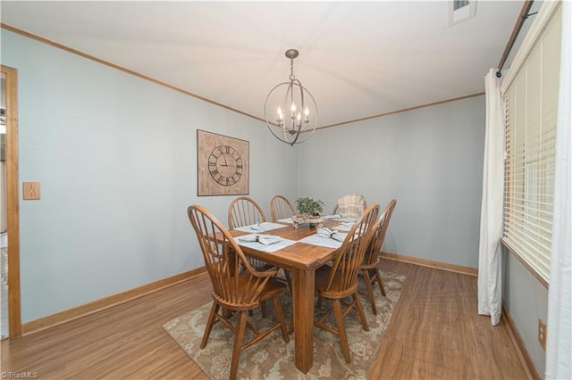 795 Morris Rd, Winston-Salem, NC 27101 - dining space featuring a chandelier, light wood-style floors, baseboards, and ornamental molding
