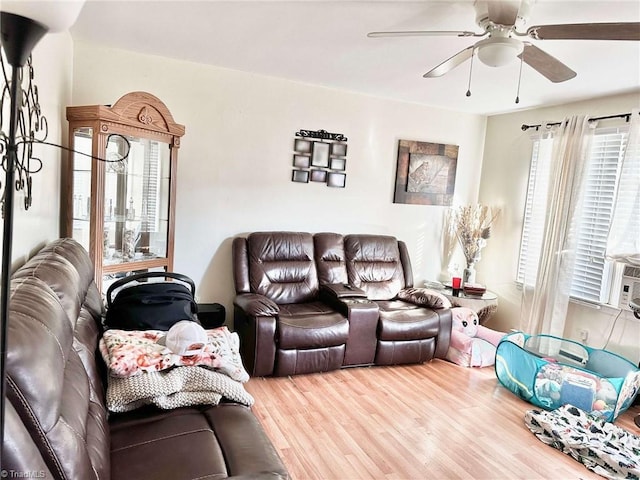 living room featuring hardwood / wood-style floors and ceiling fan