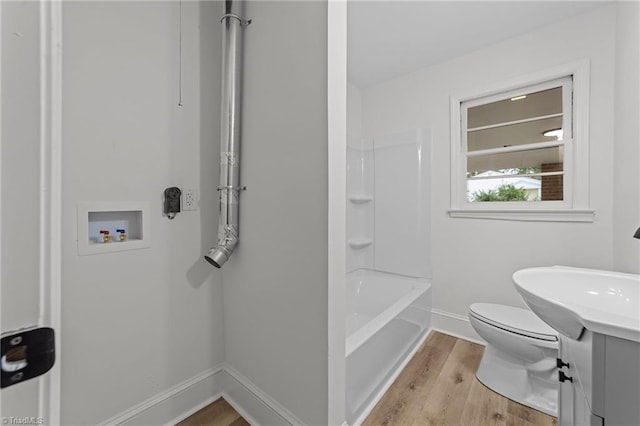 full bath featuring baseboards, wood finished floors, and toilet